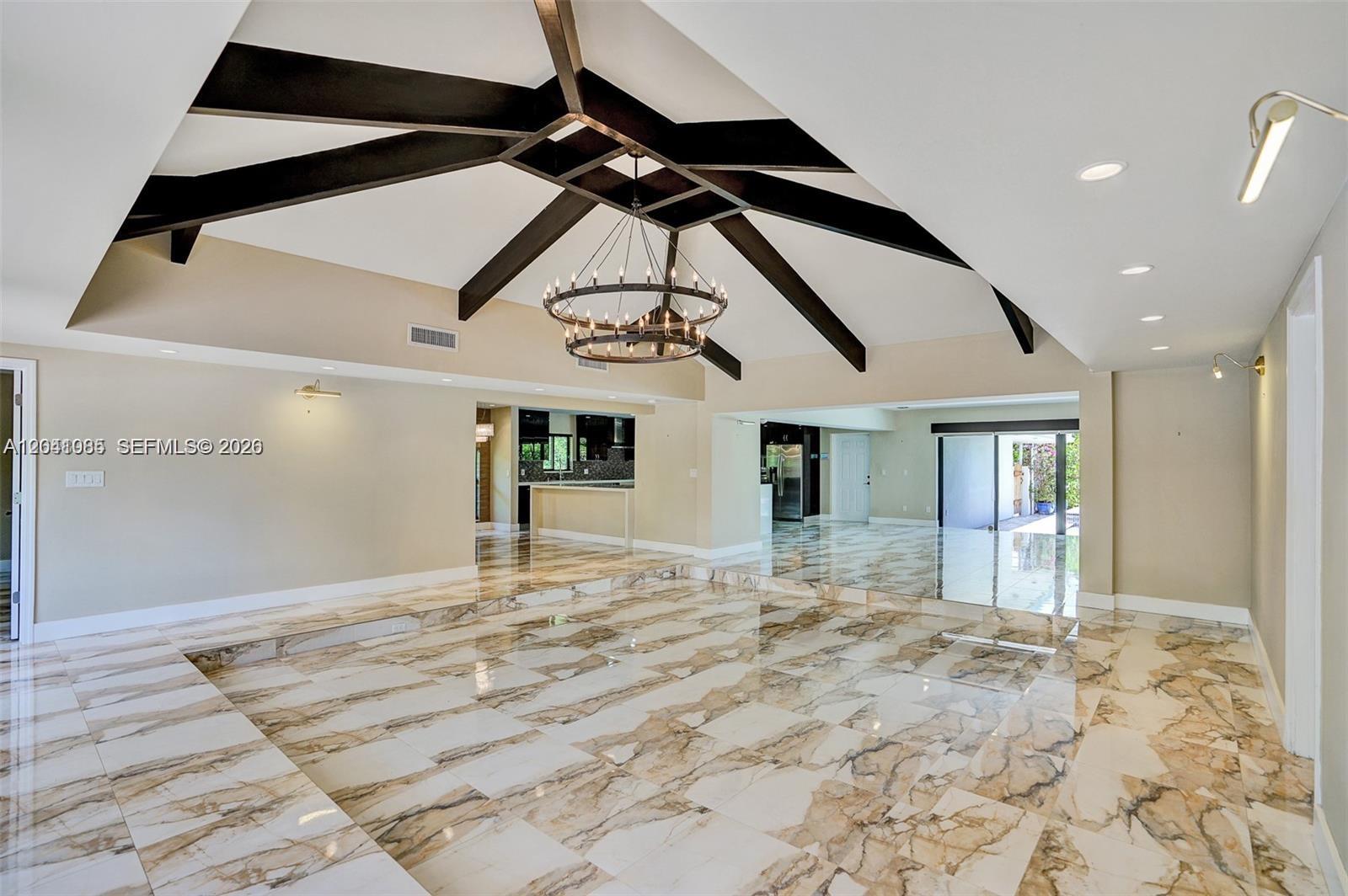 A sunken living room features marble tile flooring, a vaulted ceiling with dark wood beams — 2255 NE 120th St, North Miami FL 33181, NORTH MIAMI, FL