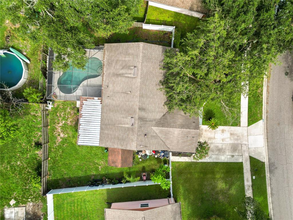 An aerial view shows a house with a pool, a screened lanai, and a fenced yard — 4820 PRESIDENTIAL STREET, SEFFNER, FL