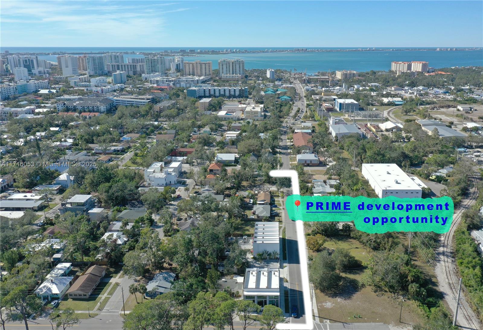 An aerial view shows a vacant lot and surrounding neighborhood near a body of water — 1744 10th st, Sarasota FL 34236, SARASOTA, FL