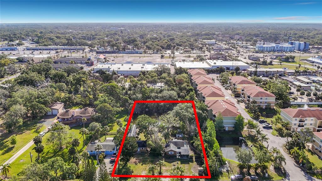 An aerial view shows a residential lot outlined in red, surrounded by trees and buildings — 6420 & 6426 OELSNER STREET, NEW PORT RICHEY, FL