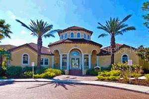 A yellow stucco building with a central rotunda and palm trees under a blue sky — 5711 BENTGRASS DRIVE UNIT 19-211, SARASOTA, FL