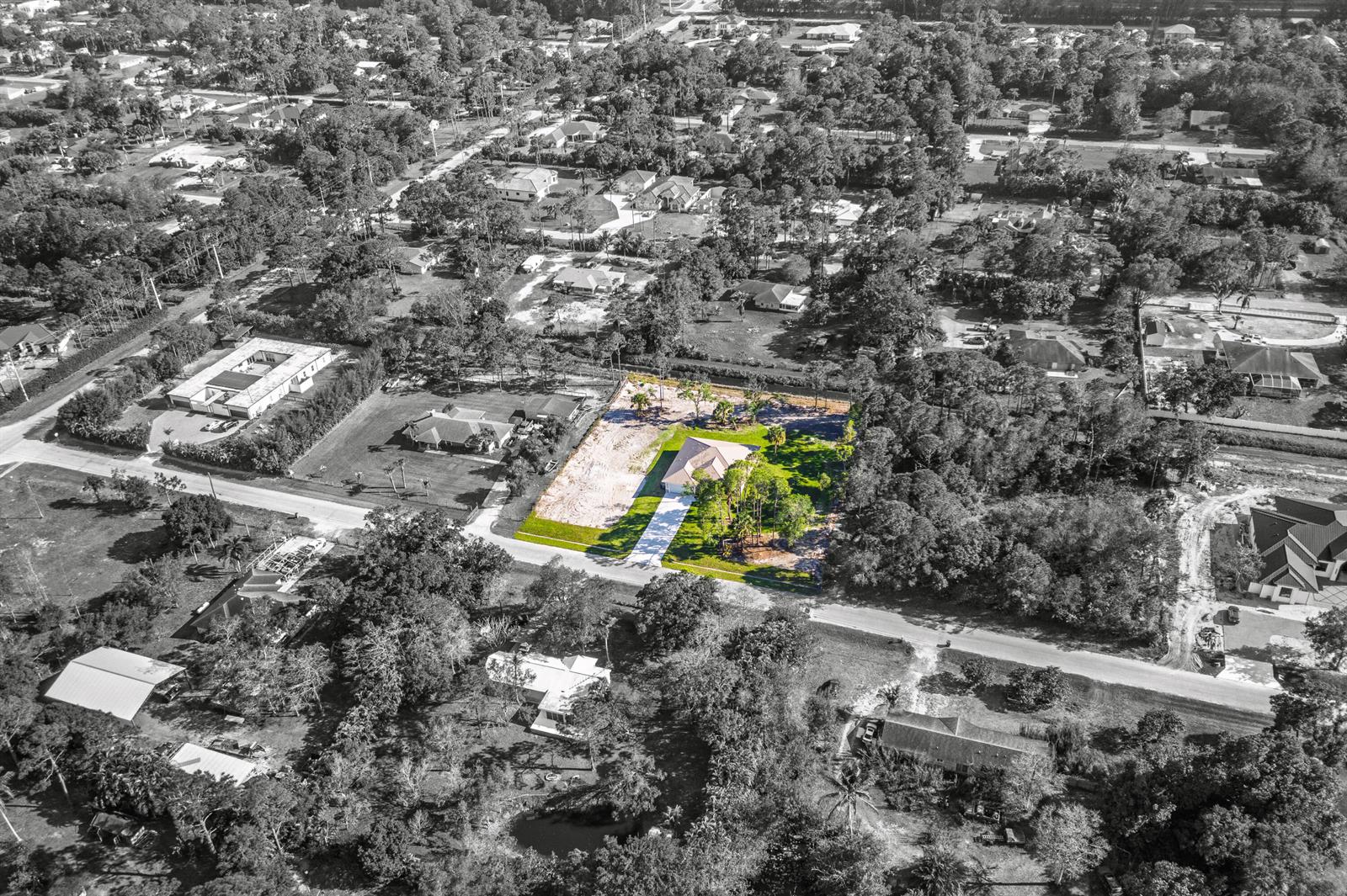 An aerial view shows a single-family house on a large, partially wooded residential lot — 17602 63rd N, FL 33470, FL