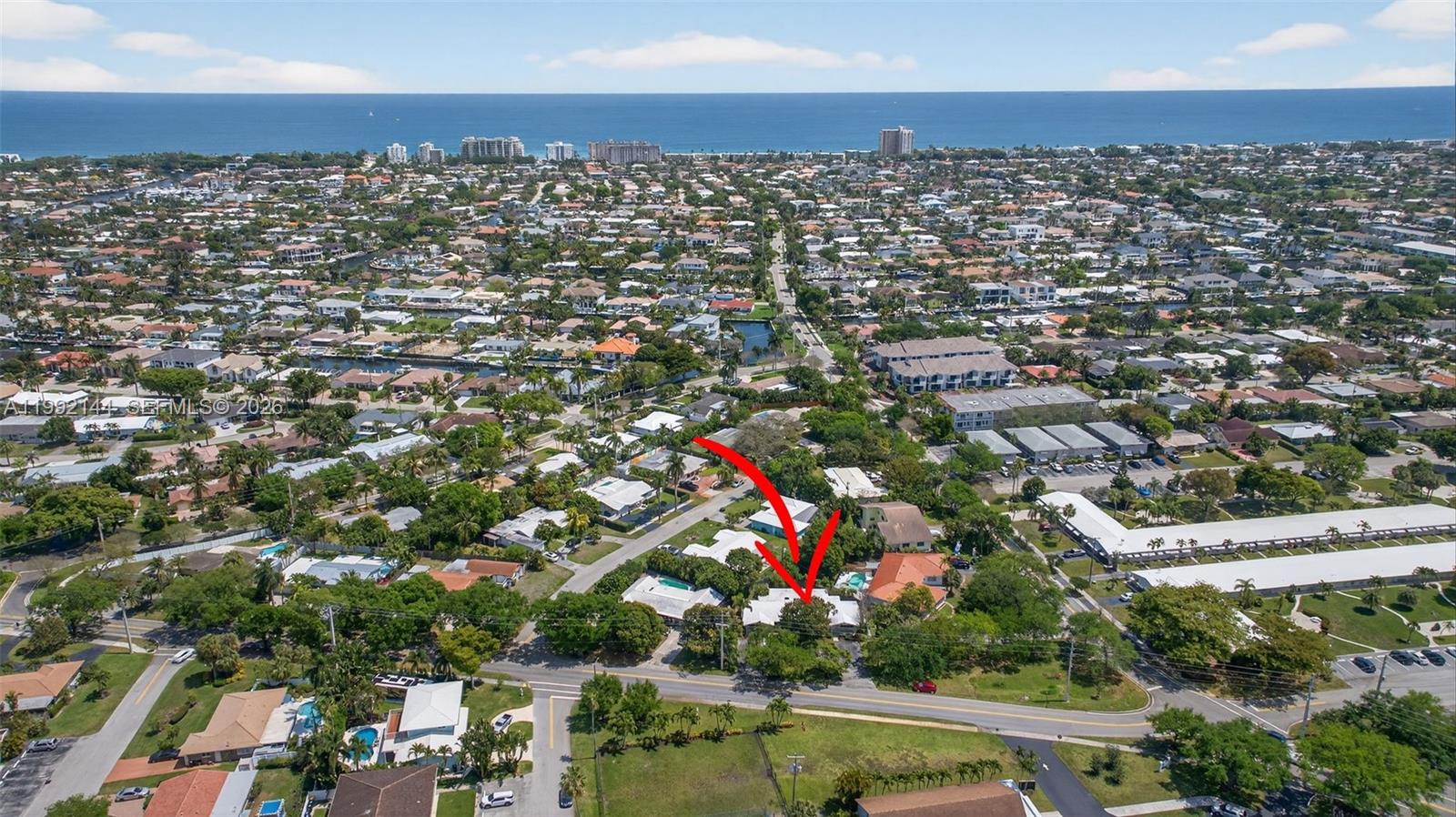 An aerial view shows a residential neighborhood with a red arrow pointing to a house — 3900 NE 22nd Ave, Lighthouse Point FL 33064, LIGHTHOUSE POINT, FL