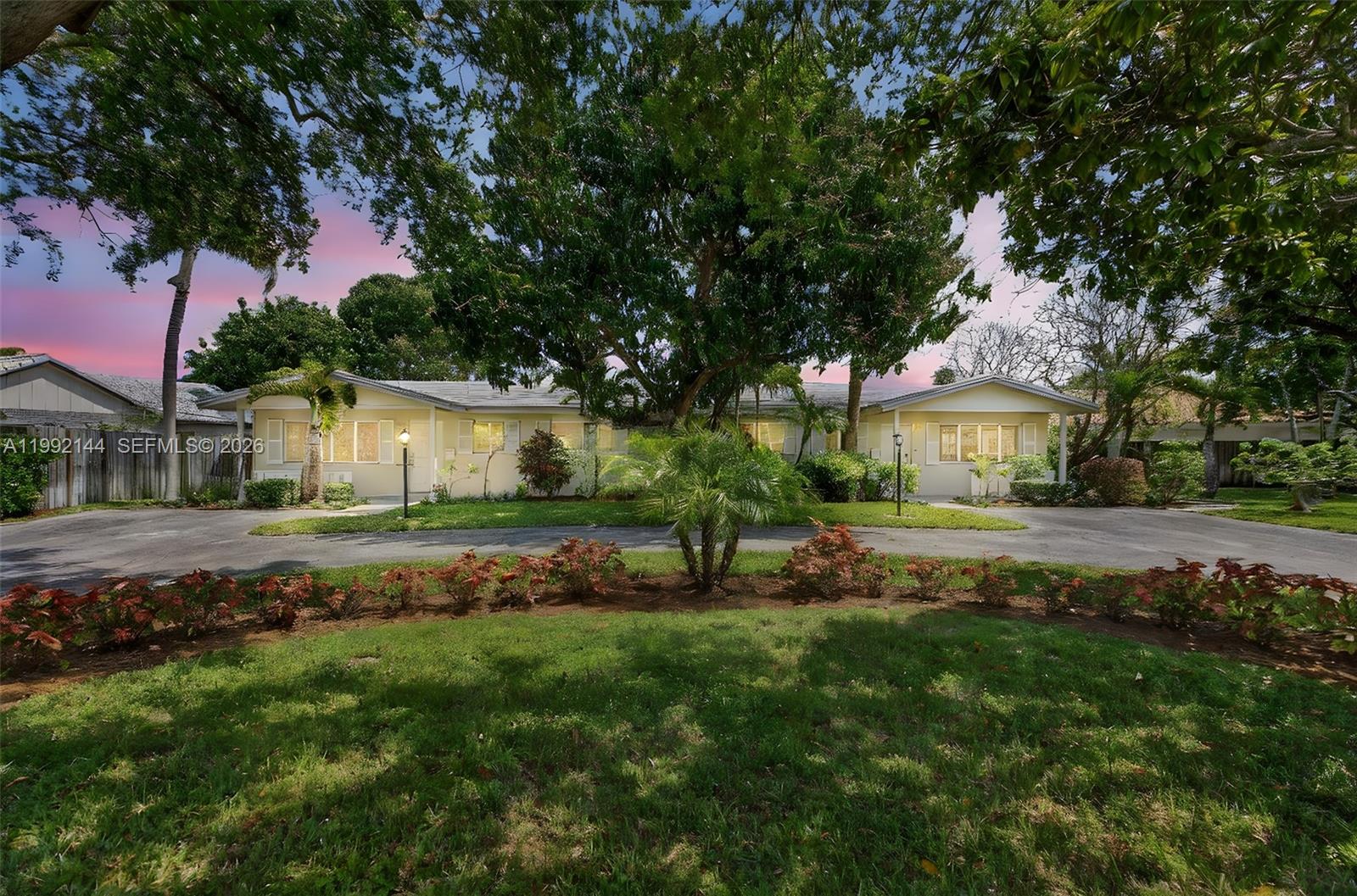 A single-story duplex with a shared driveway, mature trees, and landscaped front yard — 3900 NE 22nd Ave, Lighthouse Point FL 33064, LIGHTHOUSE POINT, FL