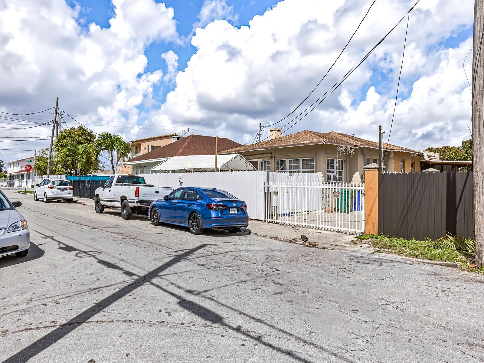 A street view shows a single-story house with a white fence and parked cars — 1757 NW 1st Street, Miami FL 33125, MIAMI, FL