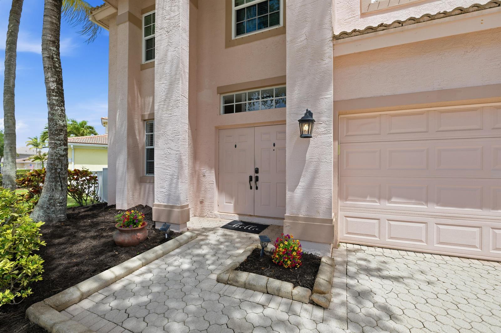 A backyard swimming pool with a patio, lounge chairs, and a white fence by a lake — 2644 San Andros, West Palm Beach FL 33411, WEST PALM BEACH, FL