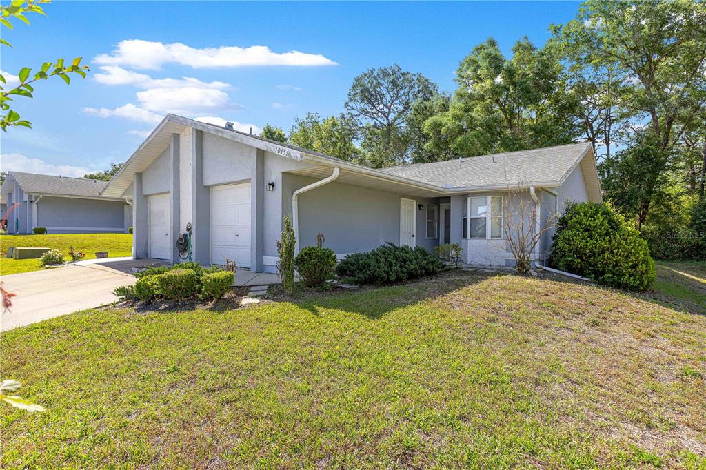 An aerial view shows a residential neighborhood with a red arrow pointing to a house — 10457 SW 85TH COURT, OCALA, FL