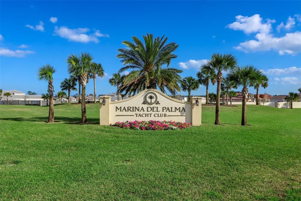 A stone monument sign for Marina Del Palma Yacht Club sits in a grassy field — 20 RIO VISTA DRIVE, PALM COAST, FL