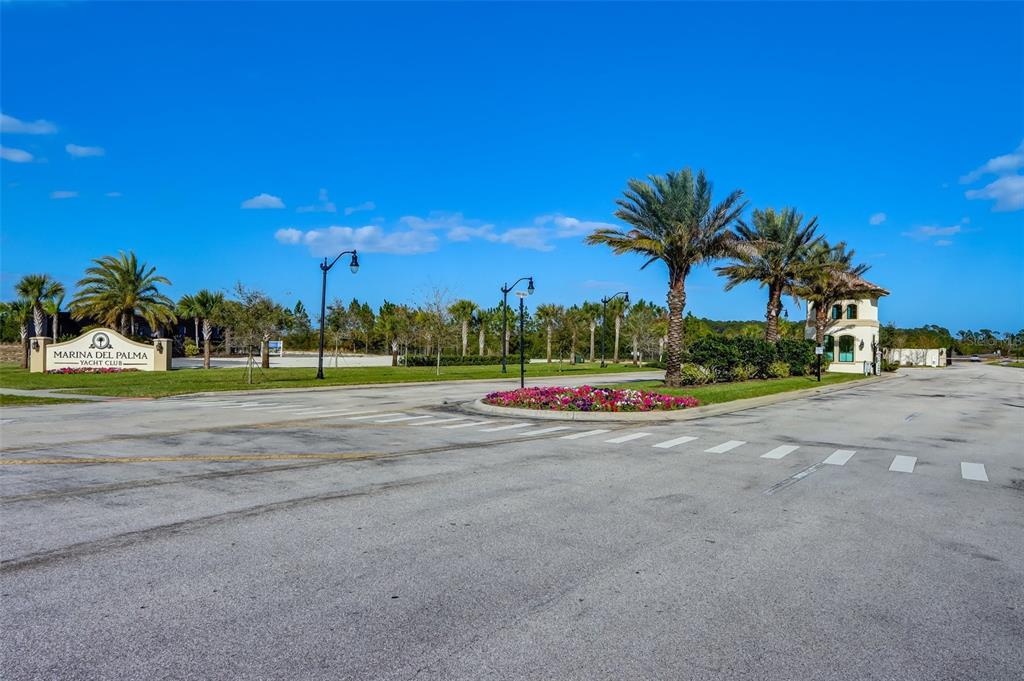 The entrance to Marina Del Palma Yacht Club features a sign, palm trees, and landscaping — 20 RIO VISTA DRIVE, PALM COAST, FL