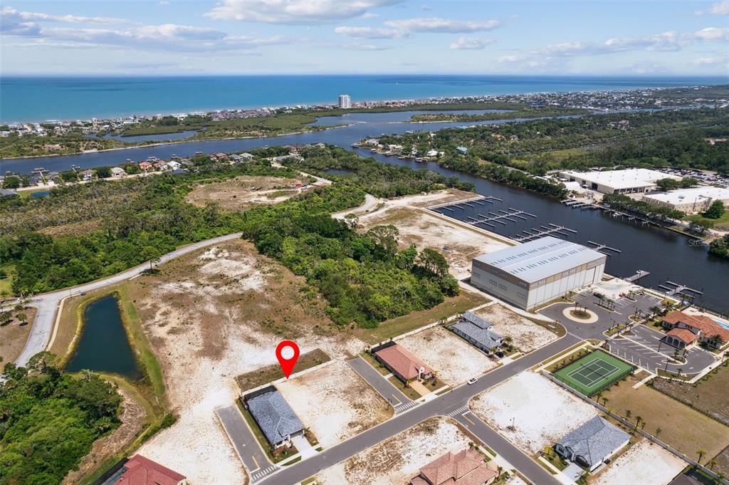 An aerial view shows a vacant residential lot marked with a pin near a waterway — 20 RIO VISTA DRIVE, PALM COAST, FL