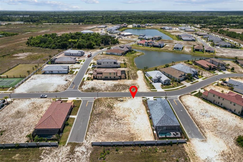 An aerial view shows a vacant residential lot marked with a pin in a neighborhood — 20 RIO VISTA DRIVE, PALM COAST, FL