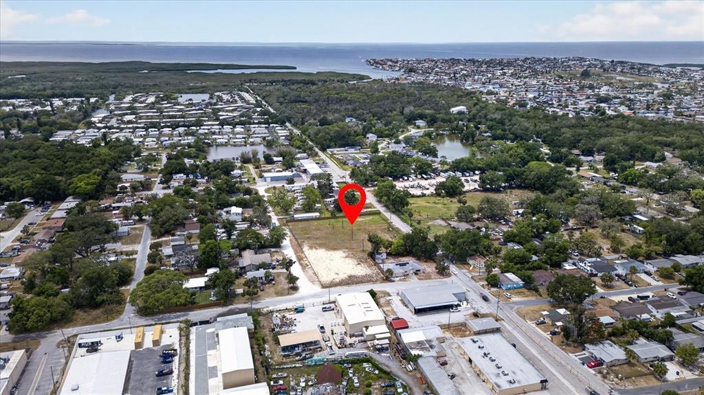 An aerial view shows a vacant rectangular lot marked with a red pin — 4710 TROUBLE CREEK ROAD, NEW PORT RICHEY, FL