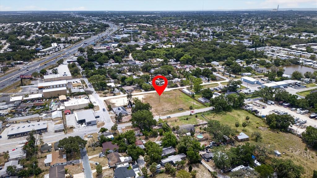 An aerial view shows a vacant, rectangular lot marked with a red pin — 4710 TROUBLE CREEK ROAD, NEW PORT RICHEY, FL