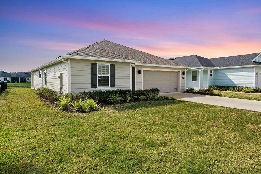 A single-story house with beige siding, a two-car garage, and a green lawn — 45 LAS CASITAS BOULEVARD, PALM COAST, FL