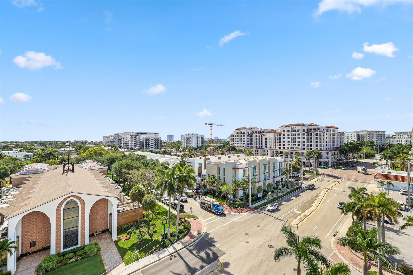 An elevated view shows a church, palm trees, city streets, and apartment buildings under a sky — 155 E Boca Raton Road Unit 703, Boca Raton FL 33432, BOCA RATON, FL