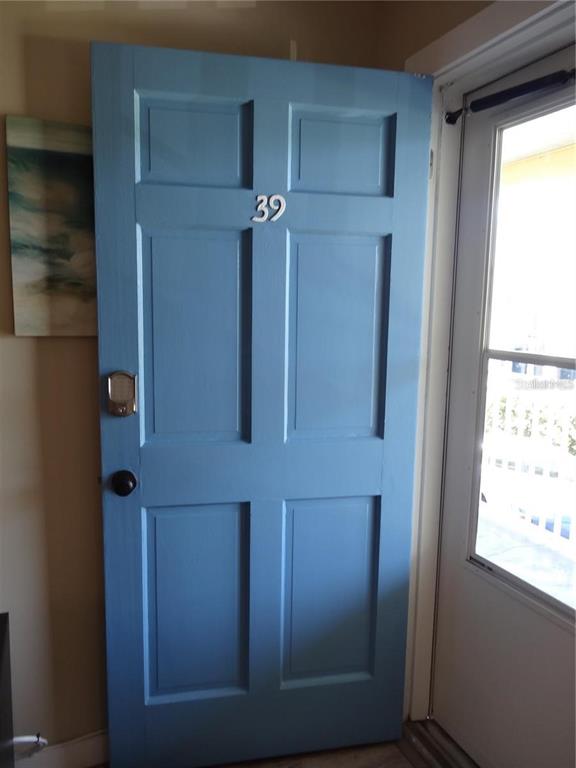 A blue interior door with the number 39 stands next to a windowed door — 9715 HARRELL AVENUE UNIT 139, TREASURE ISLAND, FL