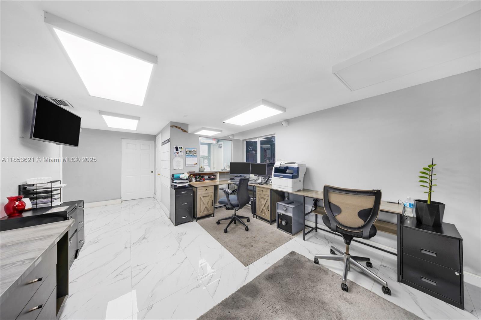 This office features white marble-look tile flooring, multiple desks, office chairs, and recessed lighting — 2696 W 3rd Ave, Hialeah FL 33010, HIALEAH, FL