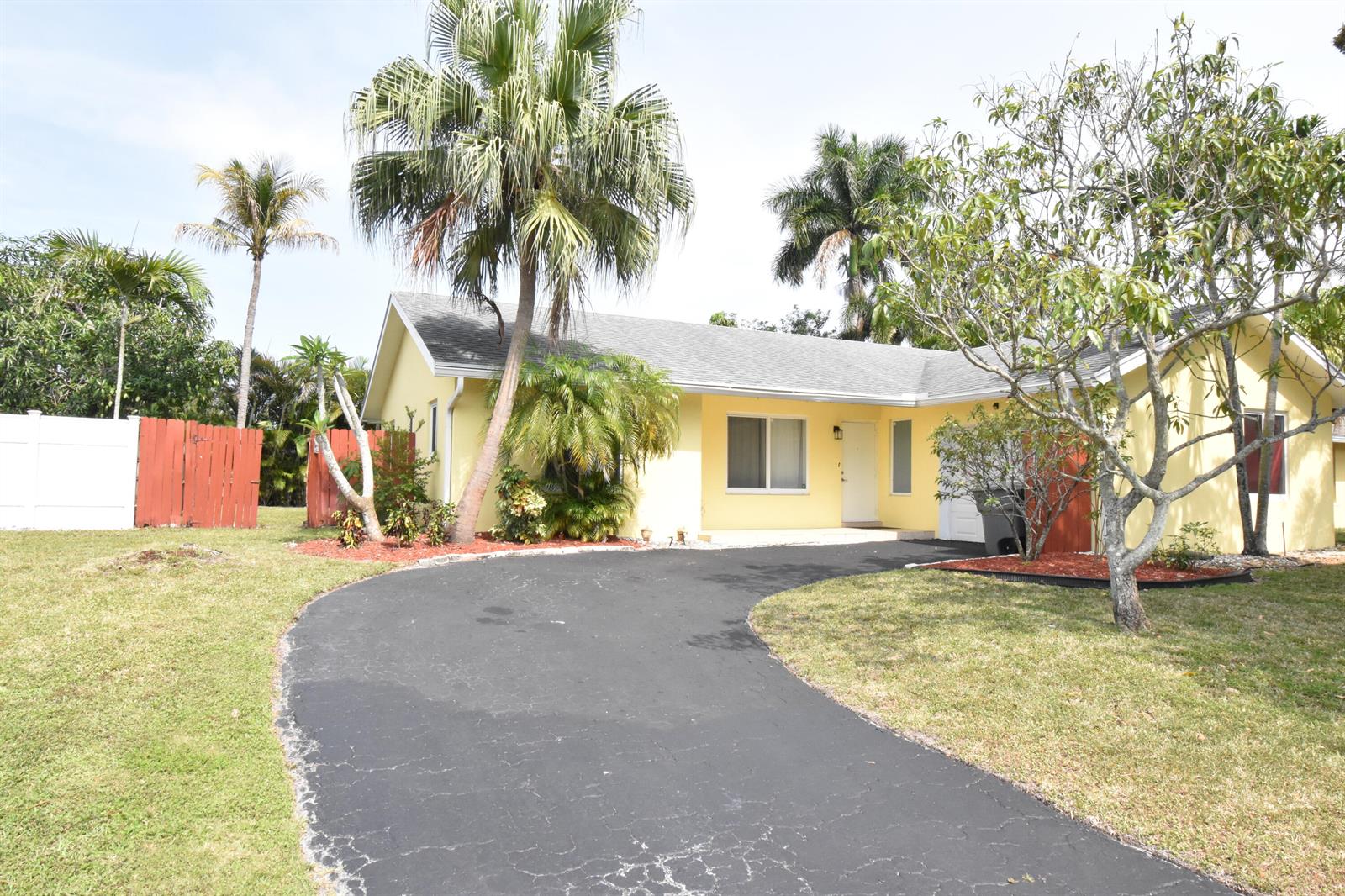 A yellow single-story house with a curved asphalt driveway and several palm trees — 9426 Southampton Place, Boca Raton FL 33434, BOCA RATON, FL