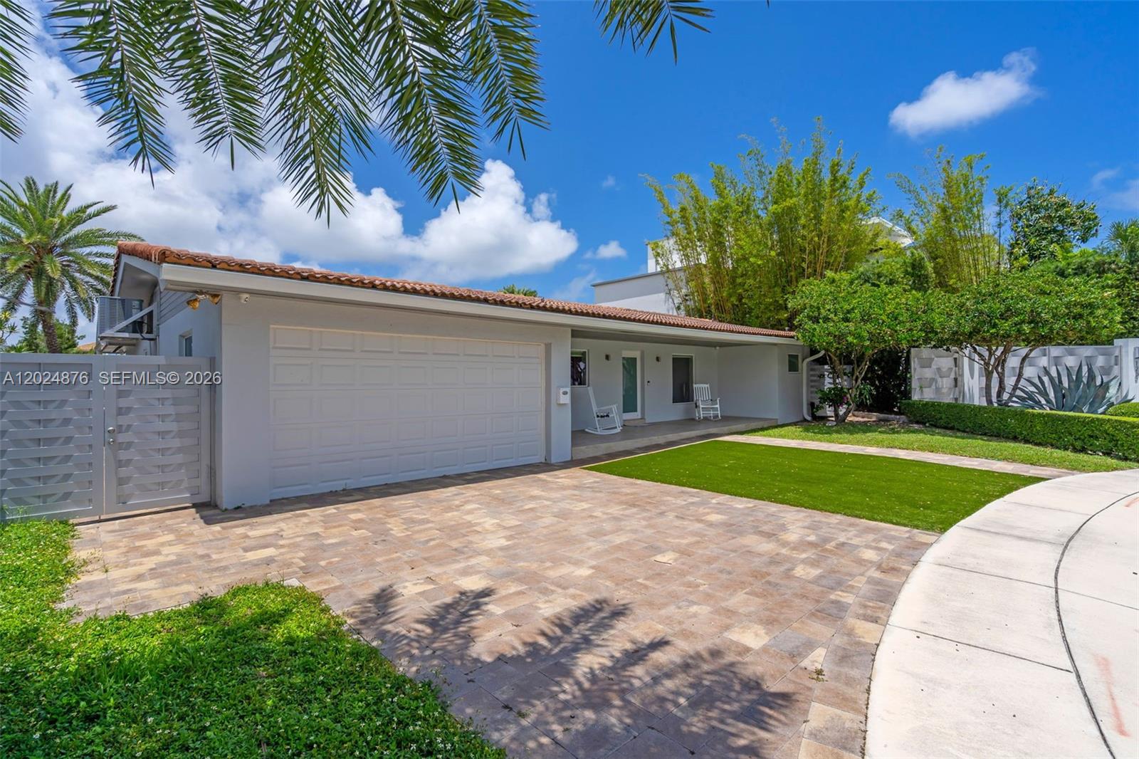 A single-story house features a paved driveway, a garage, and a covered front porch — 1261 NE 82nd St, Miami FL 33138, MIAMI, FL