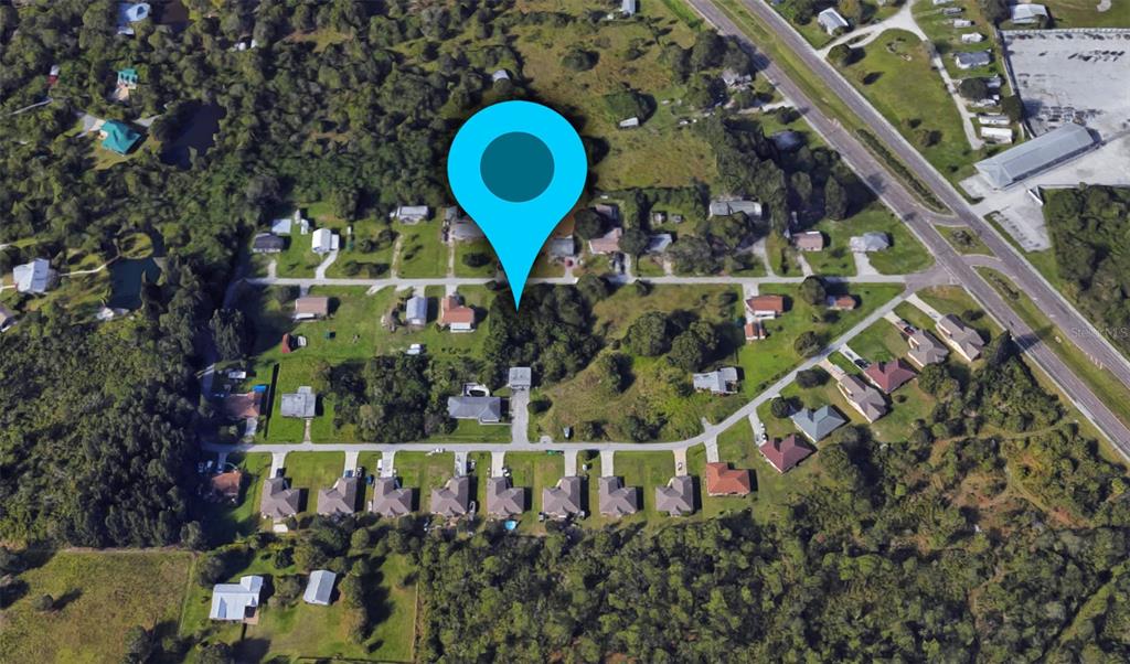This is an aerial map view of a residential neighborhood with a blue location pin — 1410 PERSAY DRIVE, PUNTA GORDA, FL