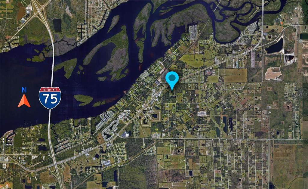 This is an aerial map showing a location pin near a river and Interstate 75 — 1410 PERSAY DRIVE, PUNTA GORDA, FL