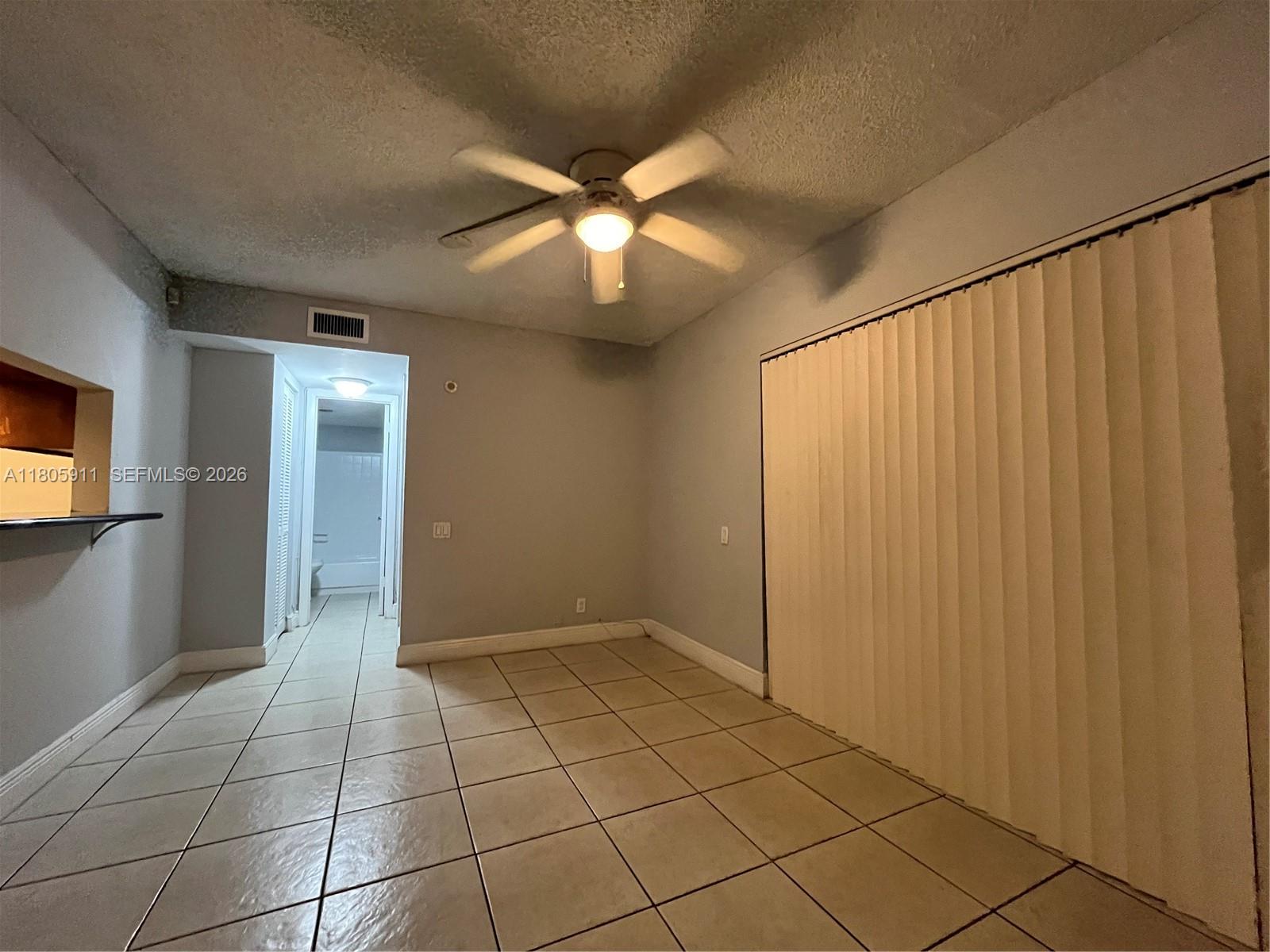 A room with tiled floors, a ceiling fan, and a sliding door closet — 4469 Treehouse Ln # B, Tamarac FL 33319, TAMARAC, FL