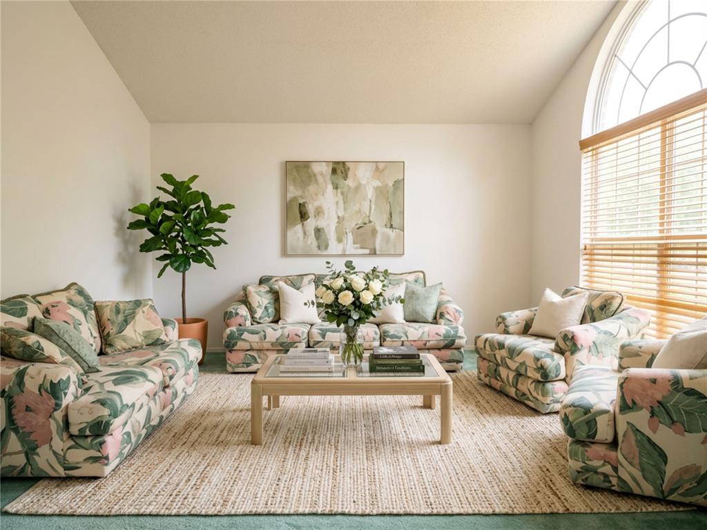 A living room features floral-patterned sofas, a central coffee table, and a large arched window — 7369 HIGH LAKE DRIVE, ORLANDO, FL