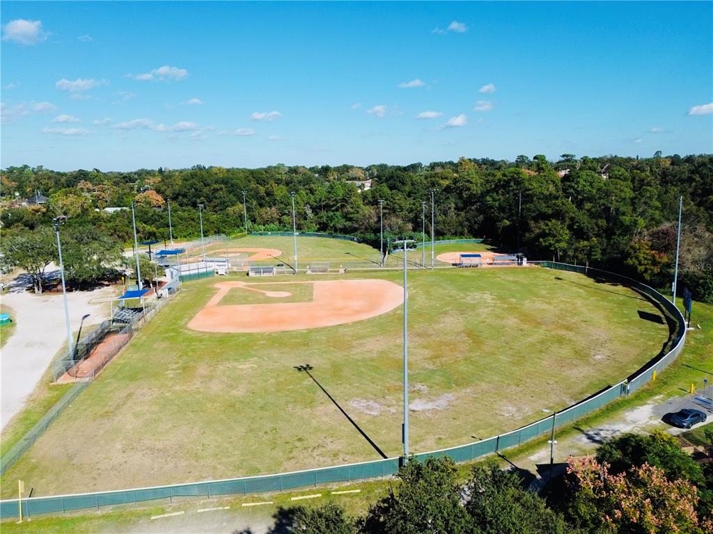 An aerial view of a baseball field with a dirt infield and outfield fencing — 1144 GERONA AVENUE, DELTONA, FL