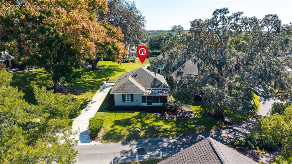 An aerial view shows a single-story house with a screened porch and surrounding trees — 1329 VILLA LANE UNIT 45, APOPKA, FL