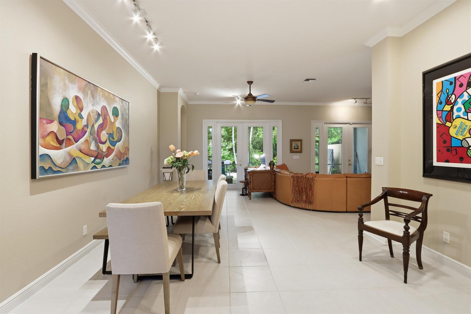 A kitchen with white cabinets, black countertops, a stainless steel refrigerator, and a framed painting — 5677 Via De La Plata Circle, Delray Beach FL 33484, DELRAY BEACH, FL