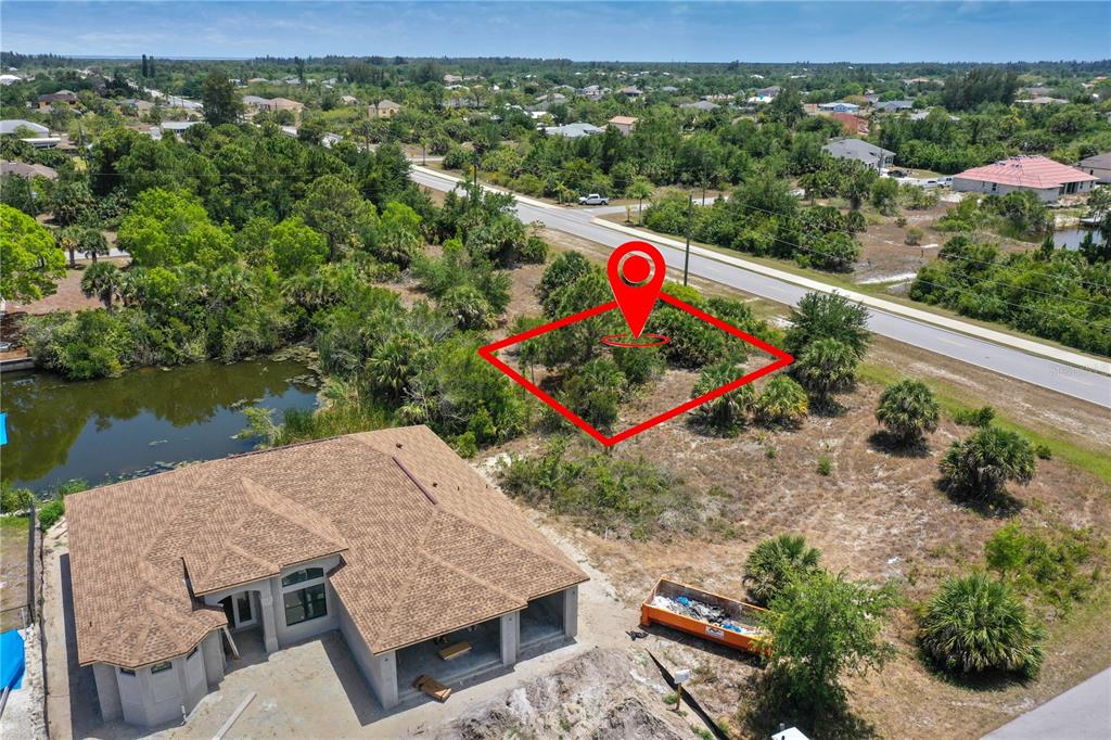 An aerial view shows a vacant lot marked with a red outline next to a house — 14530 INGRAHAM BOULEVARD, PORT CHARLOTTE, FL