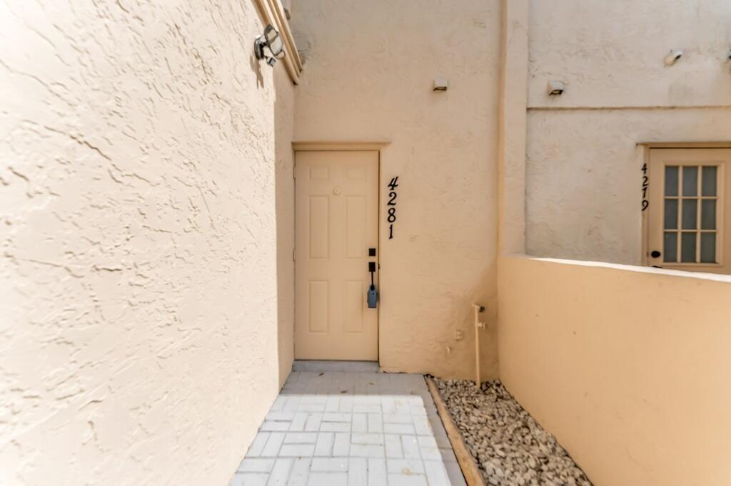 A beige exterior door with the number 4281 sits at the end of a paved walkway — 4281 NW 76th Avenue, Davie FL 33328, DAVIE, FL