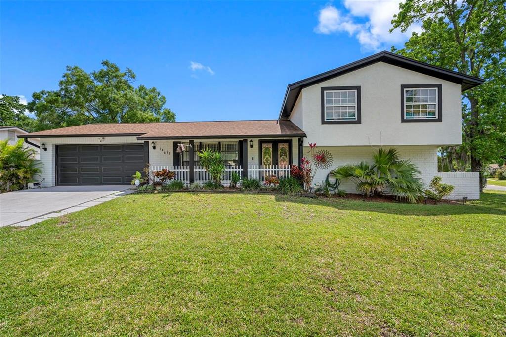 A two-story house with a white exterior, dark trim, and an attached two-car garage — 16513 SILVERHILL DRIVE, TAMPA, FL