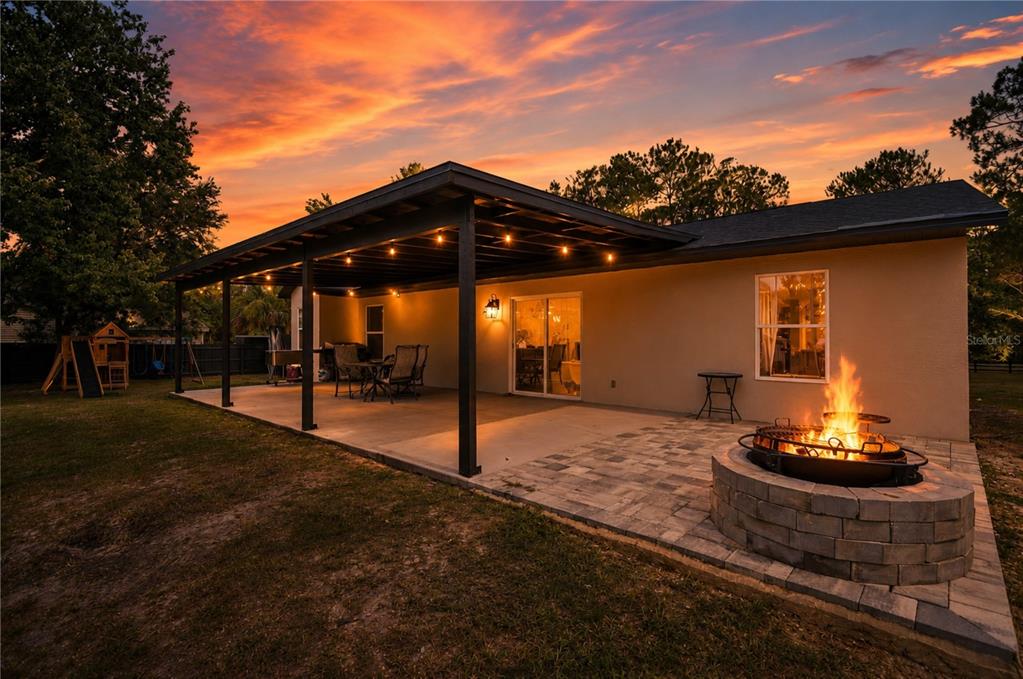 A single-story house with arched windows and a green front door at sunset — 3346 TARRAGON STREET, COCOA, FL