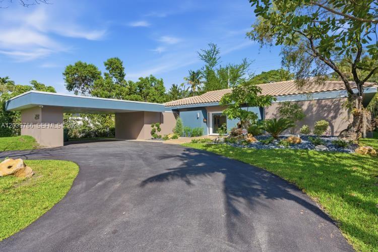 A single-story house features a flat-roofed carport and a tiled roof exterior — 291 E Shore Dr E, Miami FL 33133, MIAMI, FL