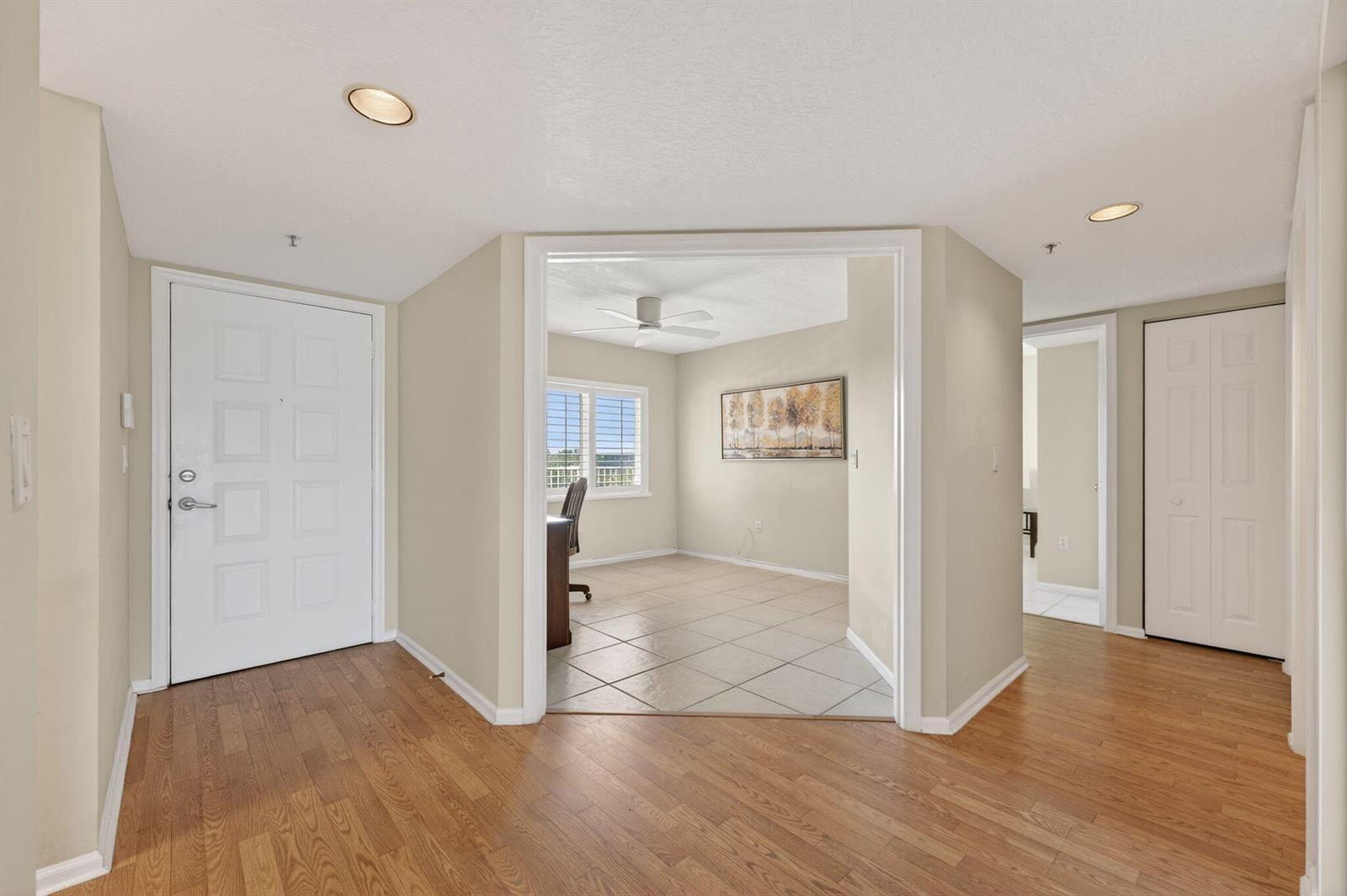 A kitchen features light wood cabinets, granite countertops, white appliances, and a dining area — 5906 Crystal Shores Drive # 404, Boynton Beach FL 33437, BOYNTON BEACH, FL