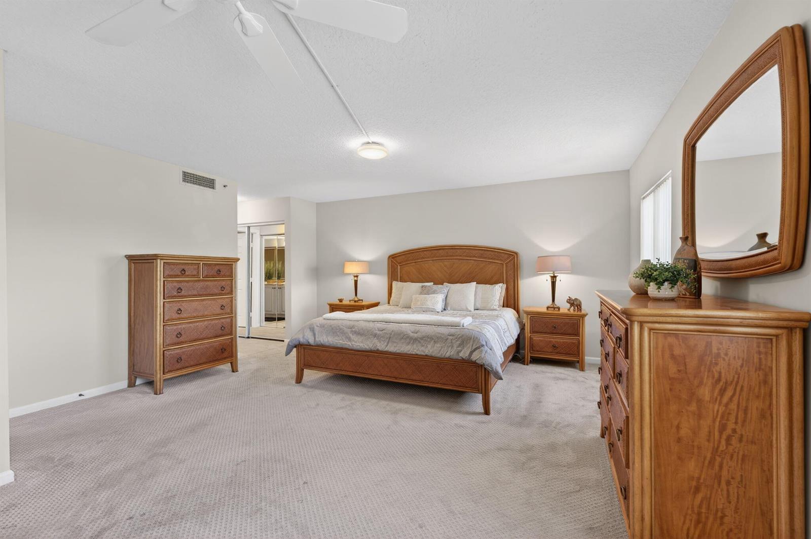 An entryway with wood flooring leads to a tiled room with a ceiling fan — 5906 Crystal Shores Drive # 404, Boynton Beach FL 33437, BOYNTON BEACH, FL