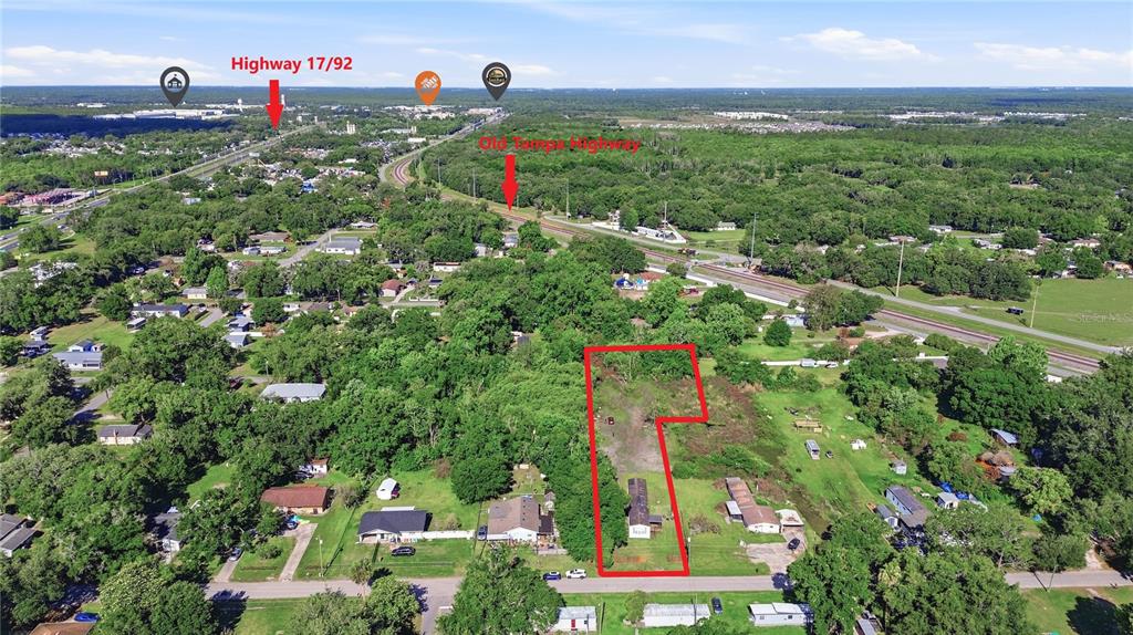 An aerial view shows a rectangular plot of land outlined in red with a structure — 1604 VINTAGE STREET, KISSIMMEE, FL