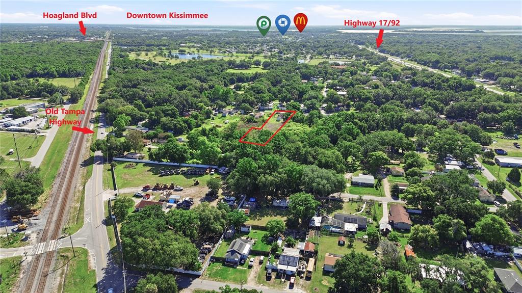 An aerial view shows a residential lot outlined in red near a railroad track — 1604 VINTAGE STREET, KISSIMMEE, FL
