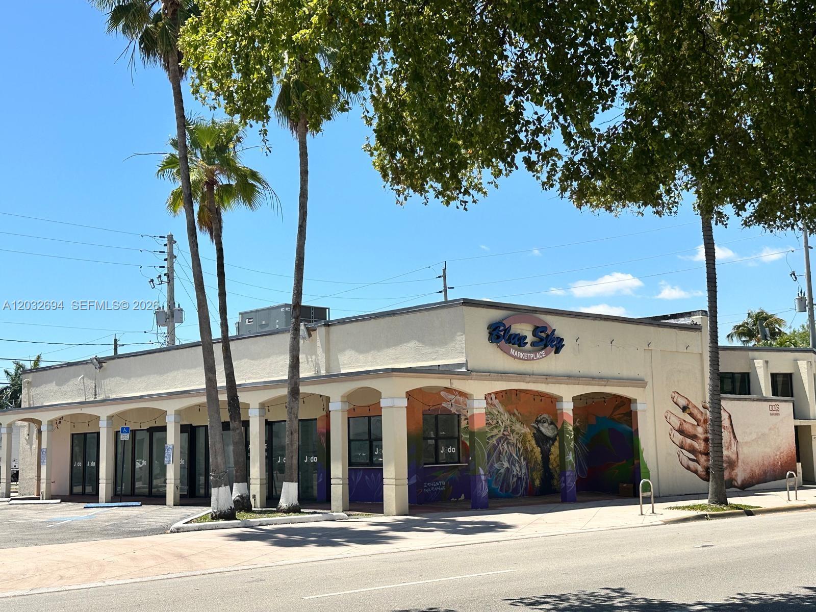 A single-story commercial building with a mural, arched covered walkway, and palm trees — 1250 Normandy DR, Miami Beach FL 33141, MIAMI BEACH, FL