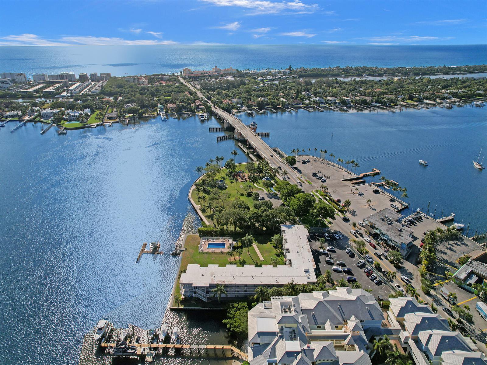 An aerial view shows a bridge crossing a bay with surrounding waterfront buildings and parks — 311 E Ocean Avenue # 205, Lantana FL 33462, LANTANA, FL