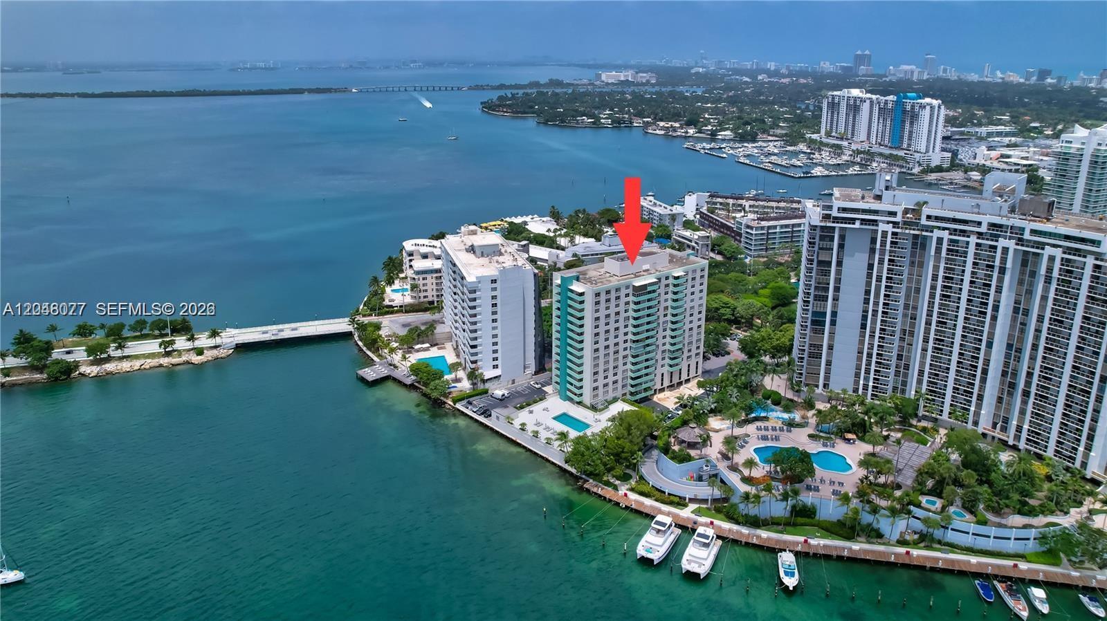 An aerial view shows a waterfront high-rise apartment building with a red arrow pointing down — 5 Island Ave # 8H, Miami Beach FL 33139, MIAMI BEACH, FL