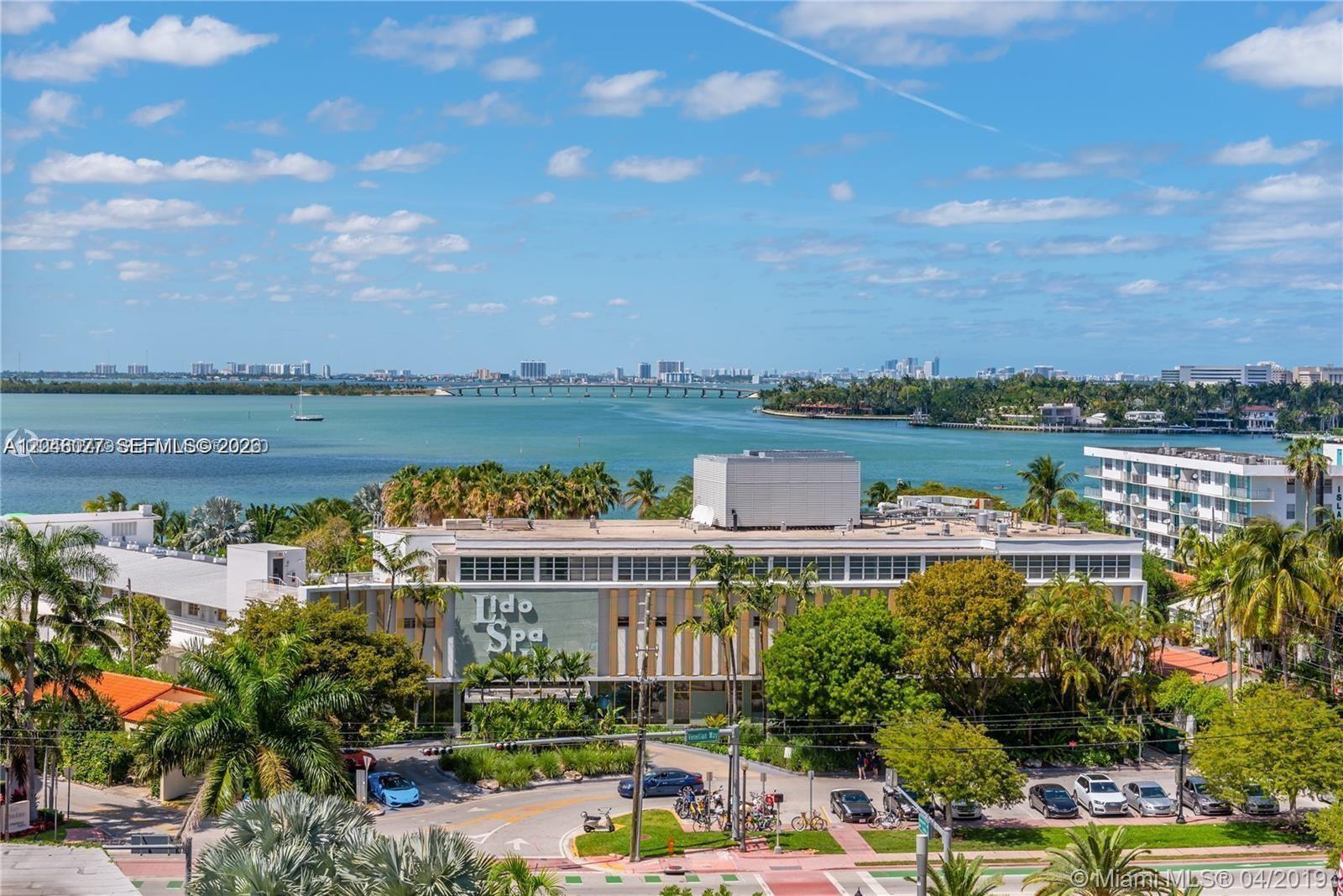 An exterior view shows the Lido Spa building surrounded by palm trees near the water — 5 Island Ave # 8H, Miami Beach FL 33139, MIAMI BEACH, FL