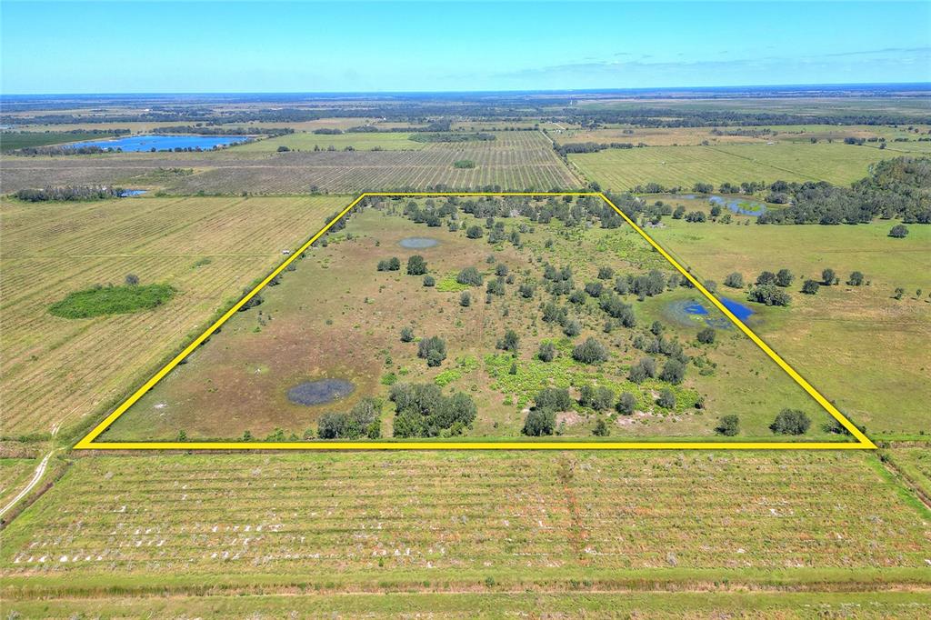 An aerial view shows a large, rectangular plot of land outlined in yellow — 46891 FARABEE ROAD, PUNTA GORDA, FL