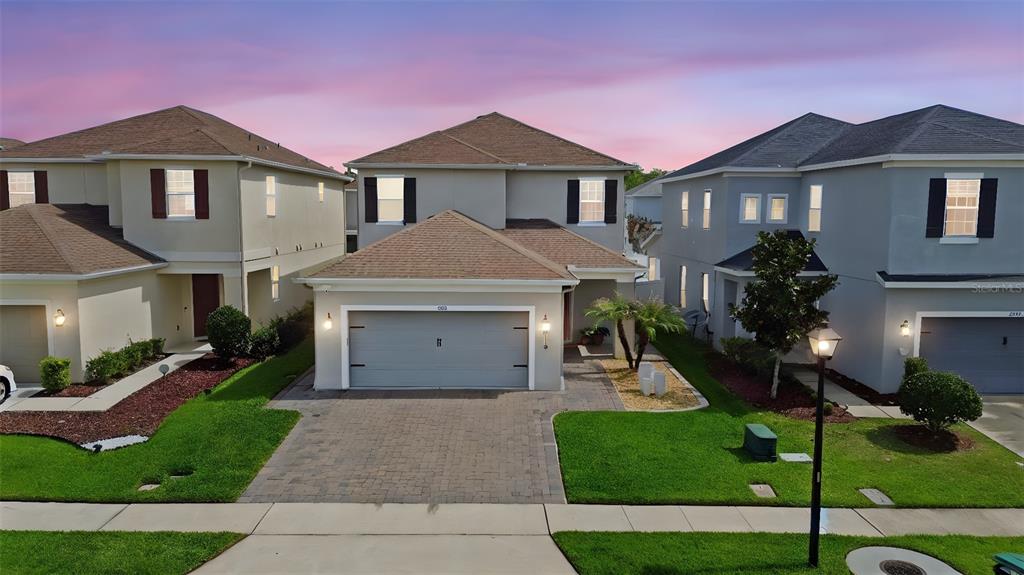 An aerial view of a two-story suburban house with a paved driveway and attached garage — 2385 DAMMAR STREET, ORLANDO, FL