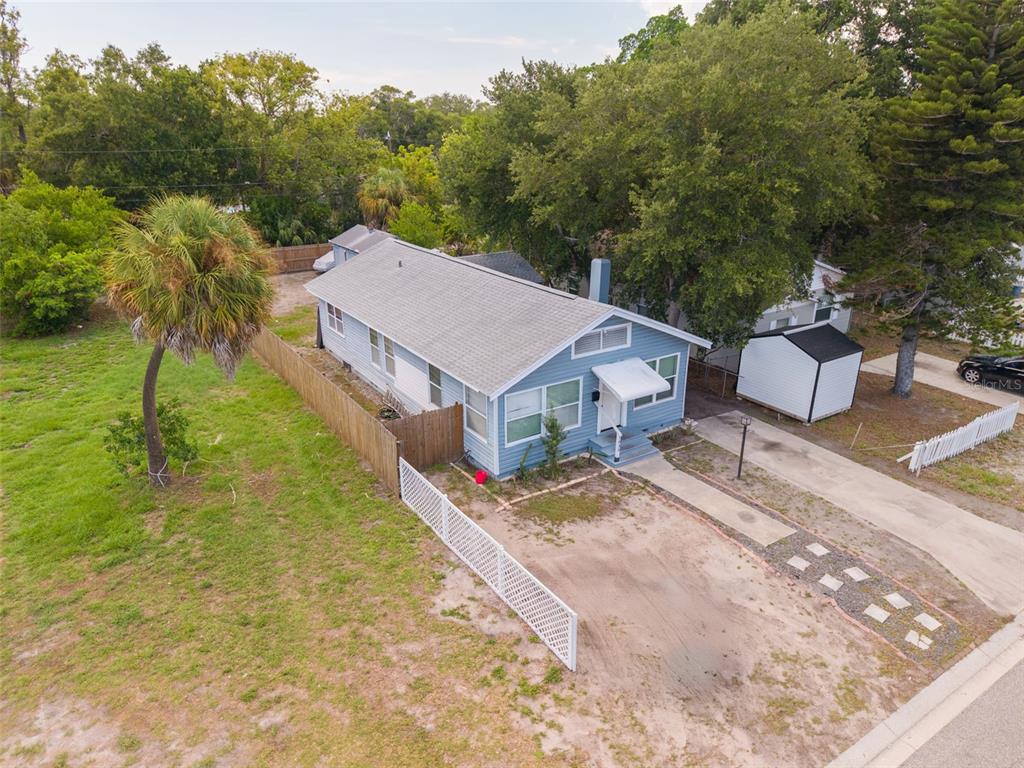 An aerial view shows a light blue house with a gray roof and a palm tree — 1835 47TH STREET S, ST PETERSBURG, FL