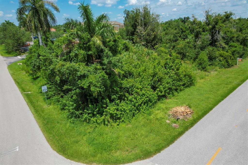 An aerial view of a vacant, overgrown corner lot bordered by two paved roads — 1010 LAVILLA ROAD, PUNTA GORDA, FL