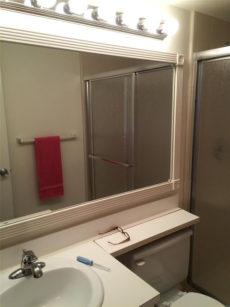 A bathroom features a vanity with a white sink, a mirror, and a glass shower enclosure — 209 Foxtail Drive # 3, FL 33415, FL