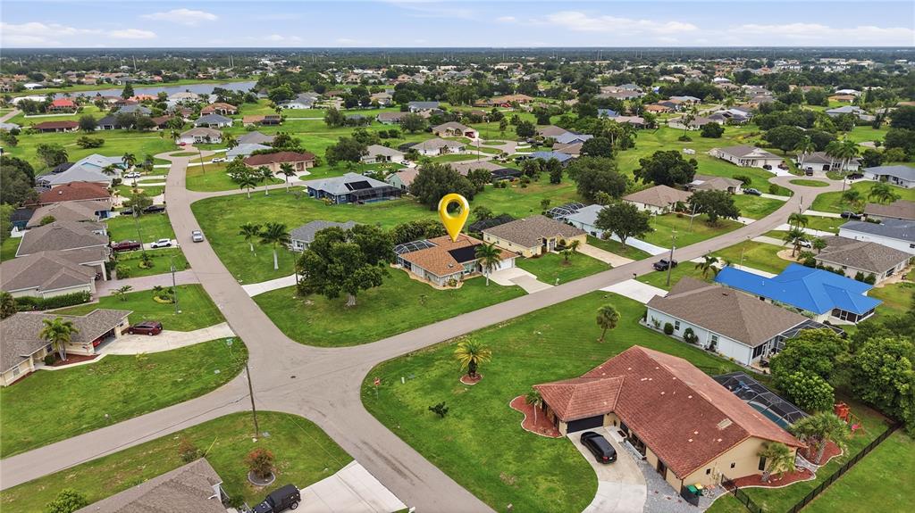 An aerial view of a suburban neighborhood featuring single-family homes with large grassy yards — 25378 RUPERT ROAD, PUNTA GORDA, FL
