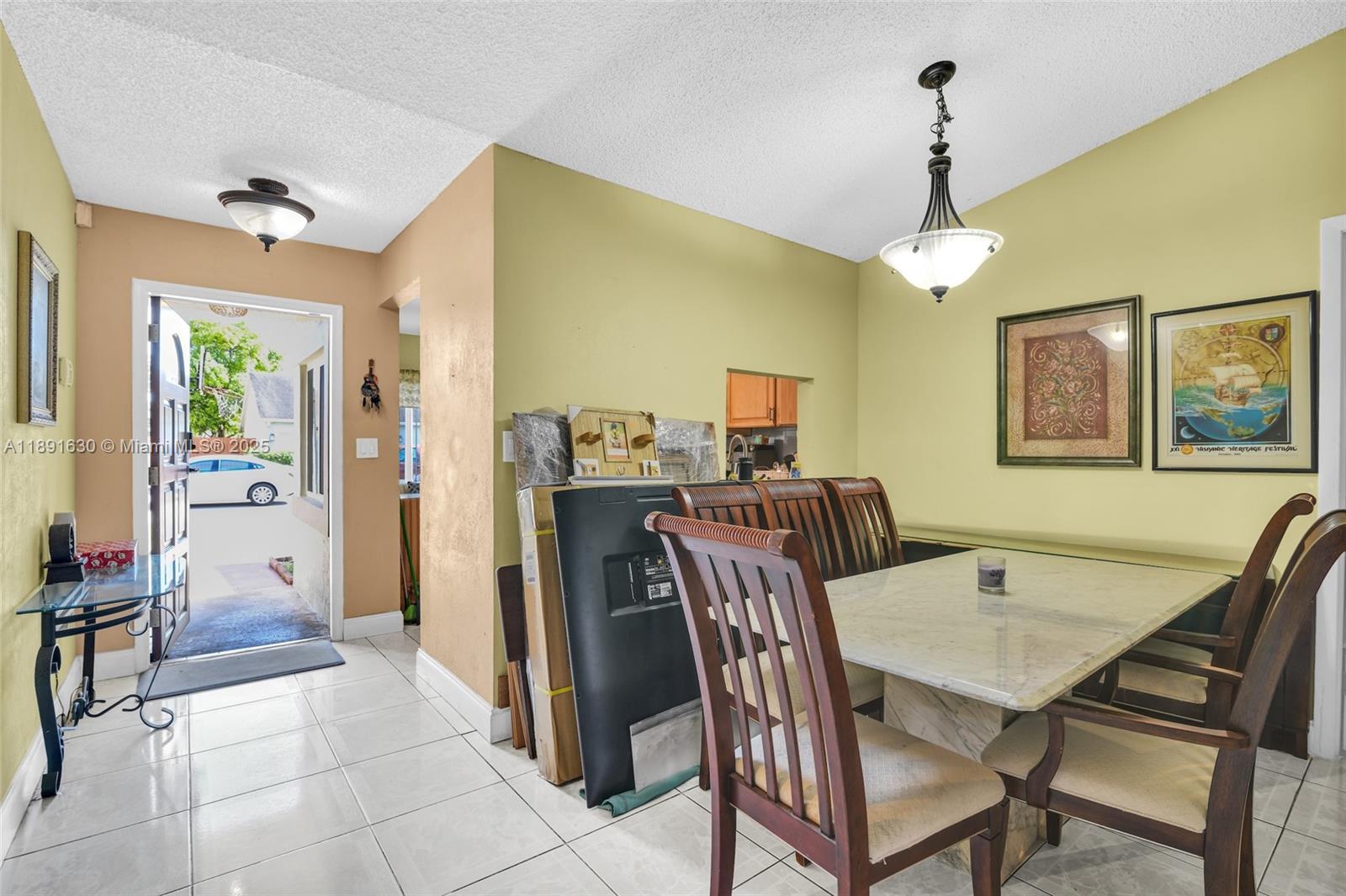 A dining area features a marble-topped table, wooden chairs, and a view of the outdoors — 13520 SW 116th Ct, Miami FL 33176, MIAMI, FL
